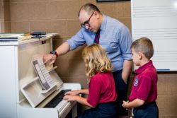 teacher and kids at piano
