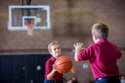 two boys playing basketball