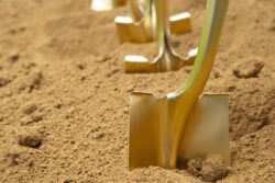 gold shovel in dirt